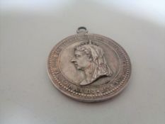 A Queen Victoria Silver Jubilee medal.