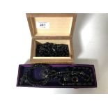 Two boxes containing Whitby Jet jewellery to include brooches, earrings, beaded necklaces.