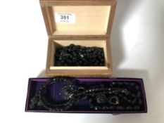 Two boxes containing Whitby Jet jewellery to include brooches, earrings, beaded necklaces.