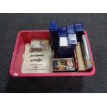 A box containing stamps relating to aviation, matchbooks, coin collecting cases and books.