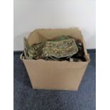 A box containing a quantity of army surplus items.