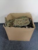 A box containing a quantity of army surplus items.