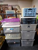 A quantity of plastic storage boxes and folding crates.