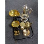 A tray containing a glass and metal wine carafe on stand,
