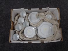 A box containing 26 pieces of Noritake white tea and dinner ware.