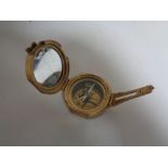 A brass cased nautical compass.