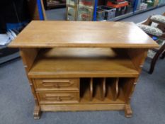 An oak entertainment stand, fitted two drawers.