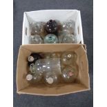 Two boxes containing thirteen glass demijohns.