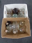 Two boxes containing thirteen glass demijohns.