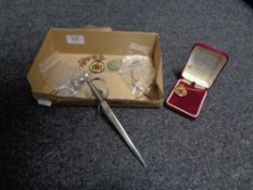 A box containing a Dutch coin bracelet, King George V medal, two enamel coins in silver mounts,