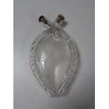 An etched glass heart shaped flask.