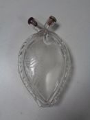 An etched glass heart shaped flask.