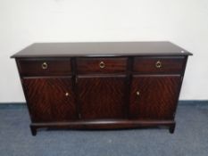 A Stag Minstrel triple door sideboard, fitted three drawers above.