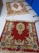 Two fringed woollen rugs with floral design