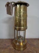 A brass miner's lamp by E. Thomas and Williams.