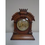 A 19th century oak cased American mantel clock by The Ansonia Clock Company.