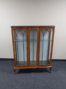 A 20th century walnut double door display cabinet.