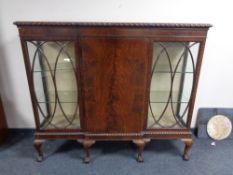 A late 19th century mahogany break front triple door display cabinet on claw ball feet.