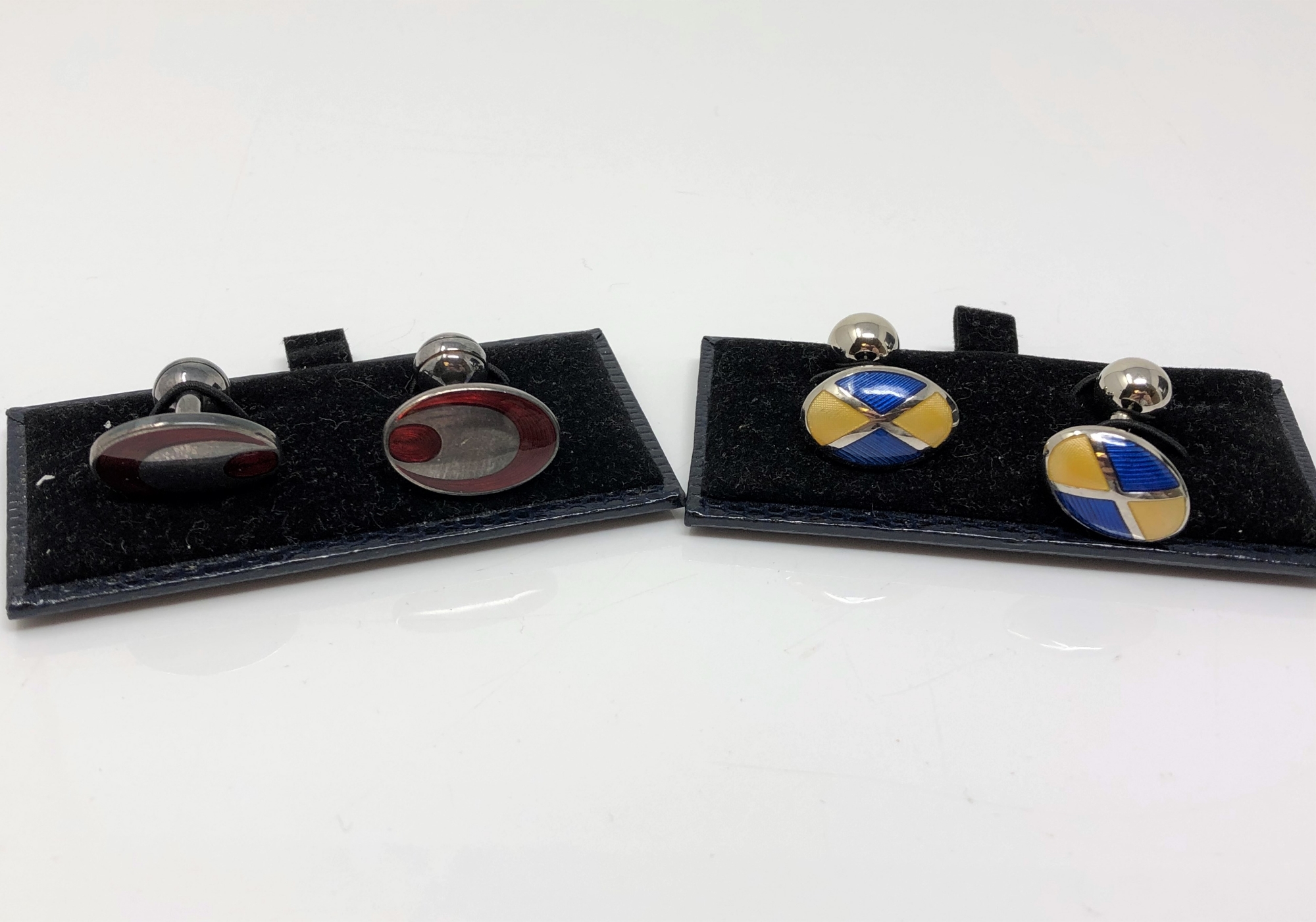 Two pairs of silver and enamelled cuff links