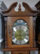 A Brixon Tempus Fugit longcase clock with pendulum and weights.