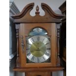 A Brixon Tempus Fugit longcase clock with pendulum and weights.