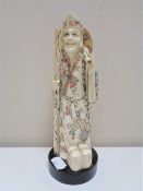 A Japanese carved bone okimono, figure with staff,