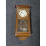 An early 20th century oak cased wall clock with silvered dial.