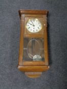 An early 20th century oak cased wall clock with silvered dial.