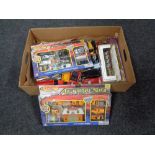 A box containing boxed and unboxed die cast vehicles and two boxed coronation carriages.