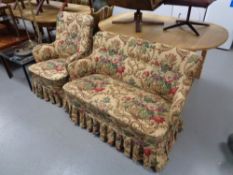 A twentieth century armchair and two seater settee in classical fabric