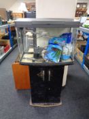 A Love Fish Panorama 64 fish tank with accessories on cupboard.