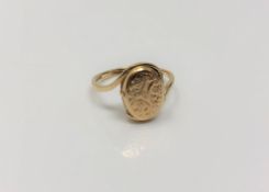 A 9ct gold ring with hinged locket head, size L, 2g.