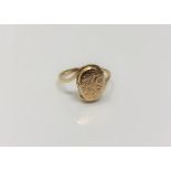 A 9ct gold ring with hinged locket head, size L, 2g.