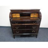A 20th century cylinder bureau, fitted three drawers.