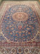 A Kashan carpet on blue ground with cream borders,