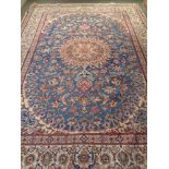 A Kashan carpet on blue ground with cream borders,