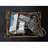 A box containing Nintendo Wii with leads together with five games (4 boxed).