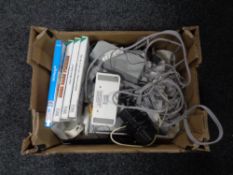 A box containing Nintendo Wii with leads together with five games (4 boxed).