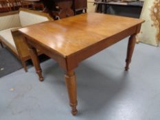 An early twentieth century oak dining table on tapered legs