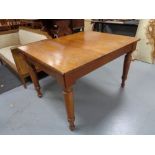 An early twentieth century oak dining table on tapered legs