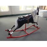 A large fibreglass rocking horse on wooden rockers