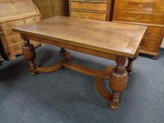 A 20th century oak pull out dining table on bulbous legs.