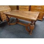 A 20th century oak pull out dining table on bulbous legs.