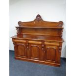 A Victorian style three drawer sideboard, fitted shelf above.