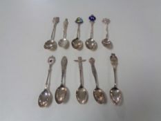 Ten silver crested teaspoons.