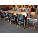 A blonde oak refectory dining table on X frame support,