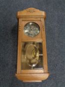 An early 20th century oak cased wall clock with silver dial.
