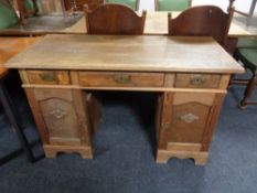 An early 20th century oak twin pedestal desk.