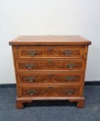 A Chapman's Siesta Georgian style burr walnut veneered four drawer chest with metal drop handles