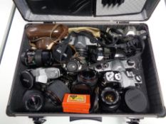 A camera case containing various cameras and lenses including Minolta,